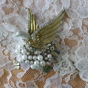 Antique bird brooch with pearl and clear stones.